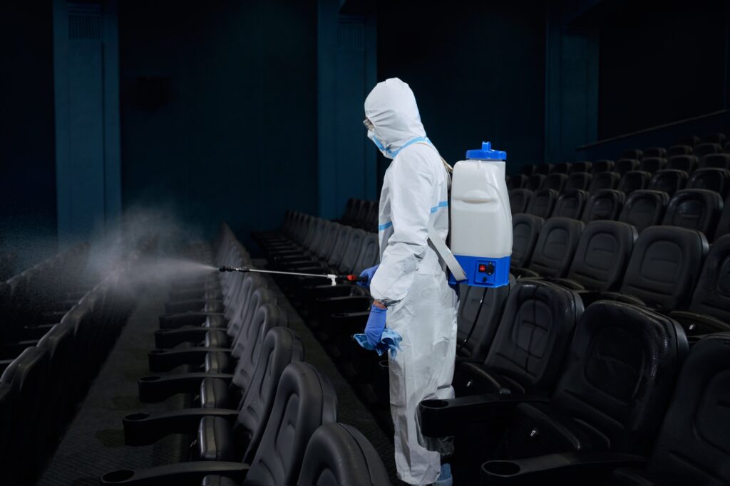 Special person making disinfection in cinema hall